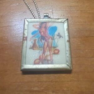Vintage lenticular “wiggle picture” pendant pin up girl on front, mirror on back